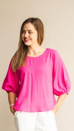 “Hot pink linen-blend puff sleeve blouse with relaxed fit by Eva Jean Collective.”