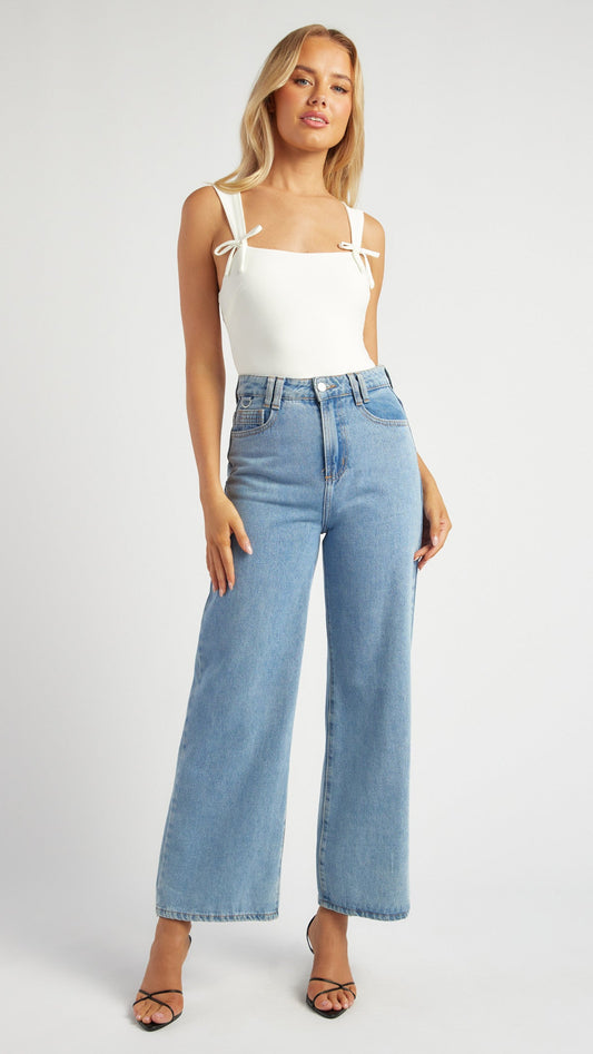 Front view of the Bowline Bodysuit styled with jeans for a chic casual look.